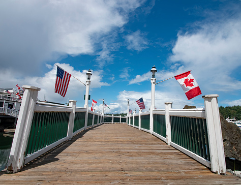 Roche Harbor - United States of America and Canada Flags Hang From the Dock