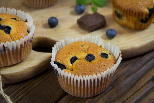 istock Muffins with blueberries, chocolate and cinnamon on a wooden board 978178566