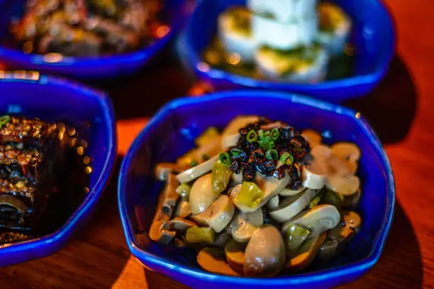 Assortment of Classic Northern China Cold Appetisers in fine-dining restaurant: button mushrooms are accentuated with Chinese truffle.