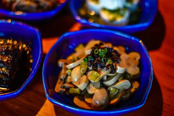 Assortment of Classic Northern China Cold Appetisers in fine-dining restaurant: button mushrooms are accentuated with Chinese truffle.