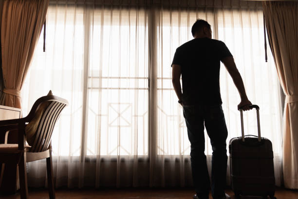 istock man holding luggage in the hotel 978183706