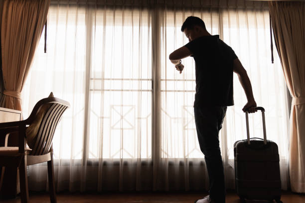 istock man holding luggage in the hotel 978183728