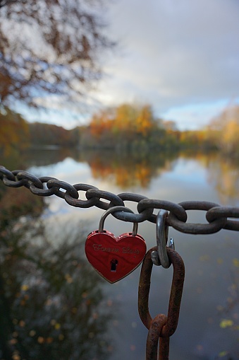 Love locks on a rusty metal rack. Shallow depth of field