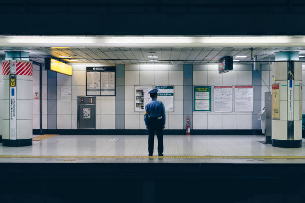 Tokyo, Japan - May 20th, 2007: A conductor waiting for the train to stop at the Tokyo subway station.