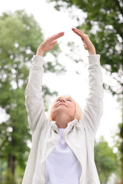 istock senior athletic woman exercising and stretching in park 978203134