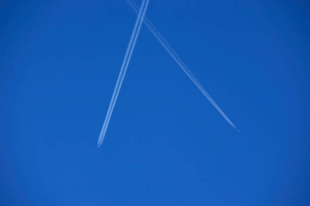 istock TWO JET AIRCRAFT VAPOUR TRAILS IN BLUE SKY 978220612