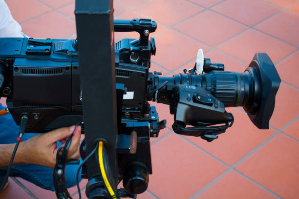 istock Cameraman checking equipment of camera in broadcast television green screen virtual studio room. 978221162