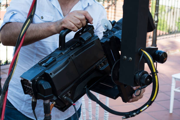 istock Cameraman checking equipment of camera in broadcast television green screen virtual studio room. 978221170