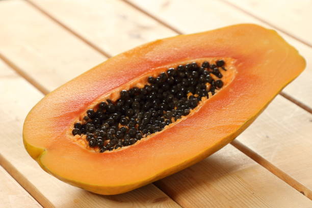 istock a half of ripe papaya fruit on a wooden table 978227488