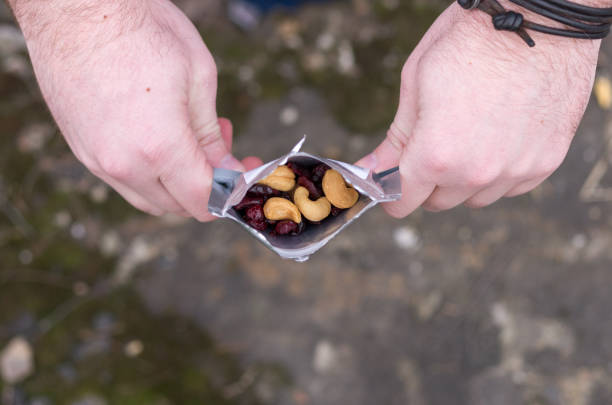 istock A man holds a package with a snack. A mix of nuts. 978237670