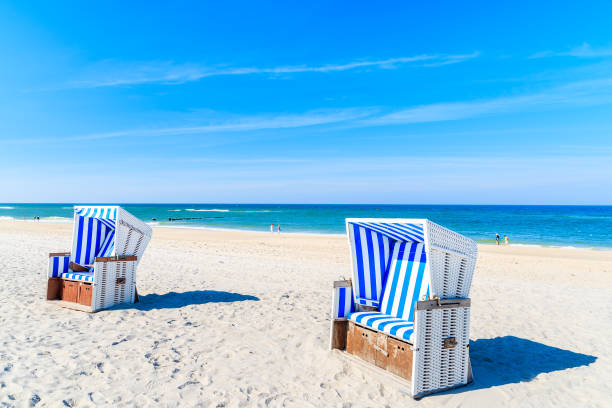 istock Wicker chairs on white sand Kampen beach, Sylt island, North Sea, Germany 978242202