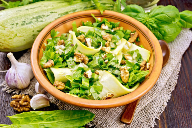 istock Salad with squash and sorrel in clay plate on board 978246426
