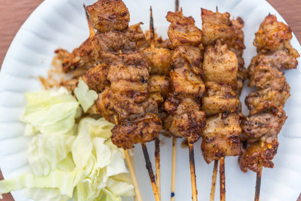Mala is Grilled meat (Beef, Pork, Chickens or Mushroom) with chilli sauce and chinese hot spicy herb (Sichuan Pepper) for sale at Thai street food market or restaurant in Bangkok Thailand