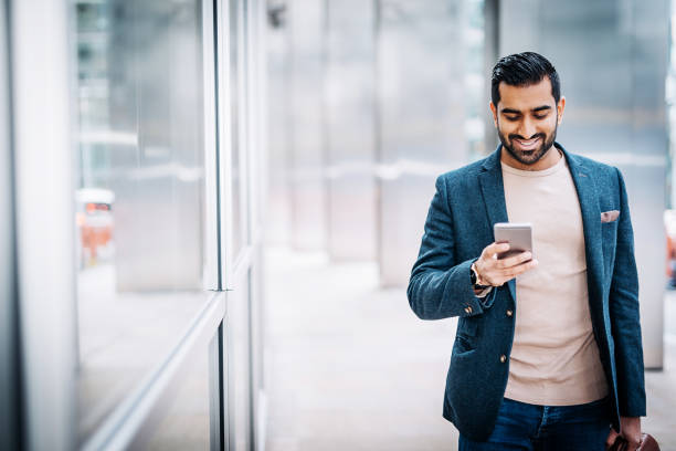 istock Businessman using smart phone near office building 978255116