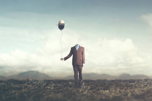 istock man without head holds black balloon with hat surreal concept 978257892