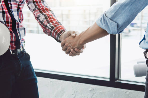 istock Meeting and greeting, Two engineer or architect meeting for project, handshake after consultation and conference new project plan, contract for both companies, success, partnership 978258458