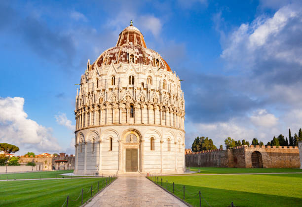 Pisa Baptistery at Piazza dei Miracoli or Piazza del Duomo in Pisa Tuscany Italy Medieval round Romanesque Pisa Baptistery of St. John (Pisa Baptistry) at Piazza dei Miracoli (Square of Miracles) or Piazza del Duomo (Cathedral Square), famous UNESCO World Heritage Site and popular tourist attraction in Pisa, Tuscany, Italy pisa stock pictures, royalty-free photos & images