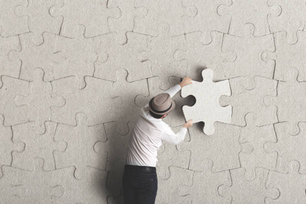man places last piece of puzzle surreal concept