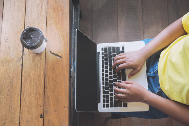 istock hipster girl hands working on her laptop 978259162