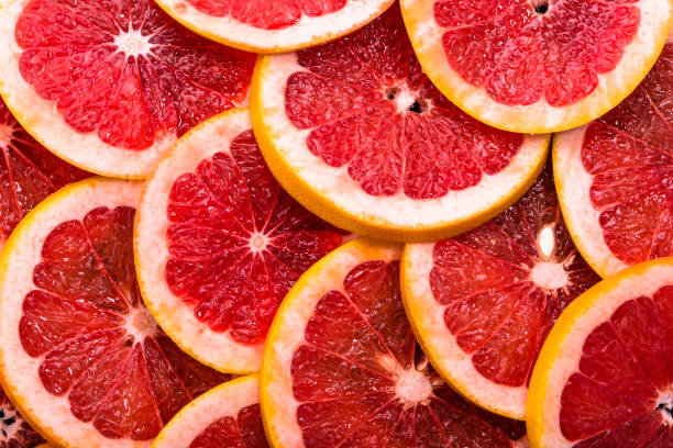 istock Sliced grapefruits, background, natural texture of citrus, top view, close-up 978261630