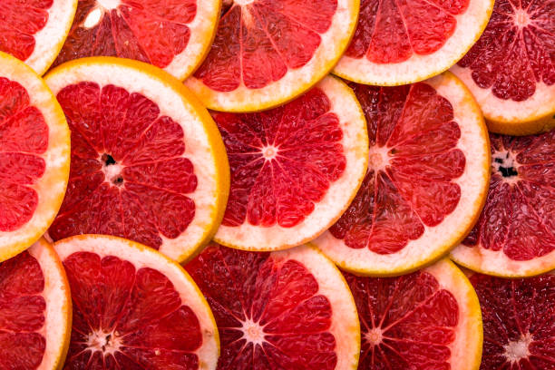 istock Sliced grapefruits, background, natural texture of citrus, top view, close-up 978261710