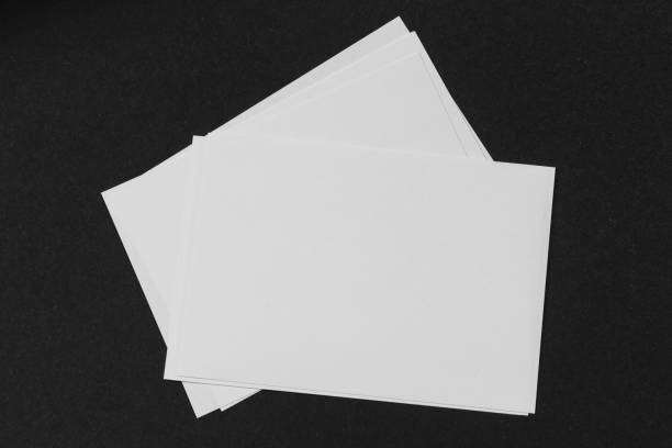 istock Blank portrait A4. brochure magazine isolated on black, changeable background / white paper isolated on black 978262178