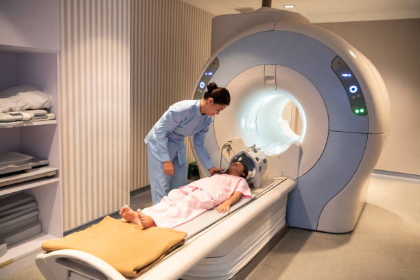 istock Female radiologist preparing girl for MRI scan 978265104