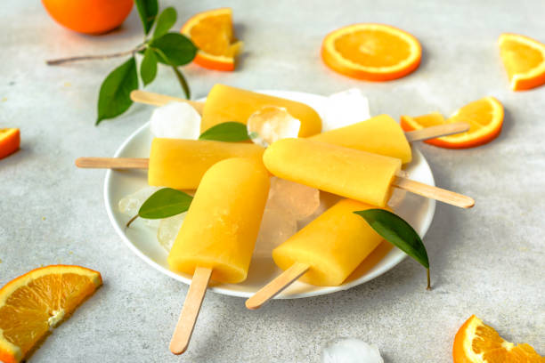 istock Homemade popsicles with orange juice, ice lollies on sticks 978265472