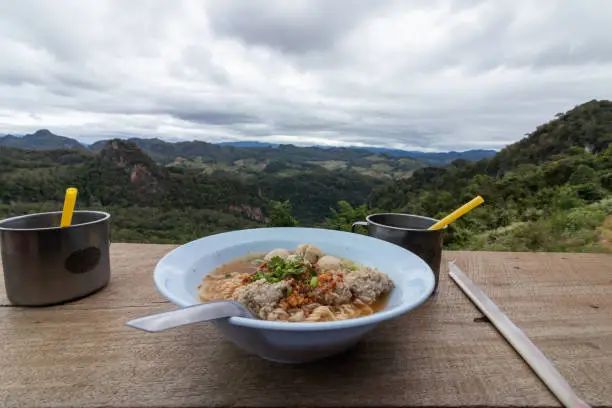 Eating noodles on the mountain with beautiful views.