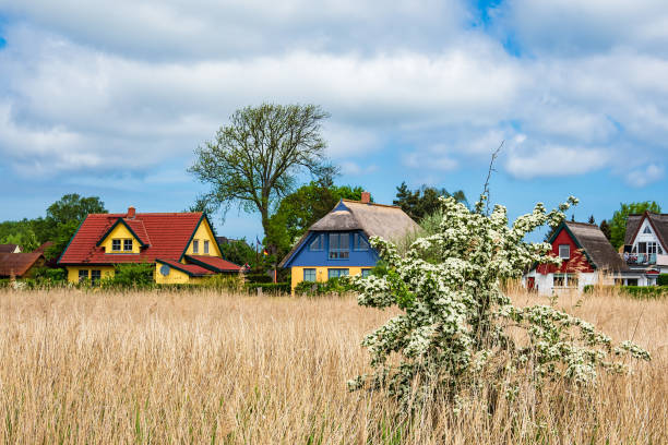 Buildings, trees and clouds in Wiek, Germany.