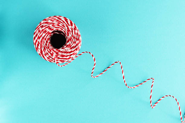 istock red white packing Christmas rope on blue background 978270820