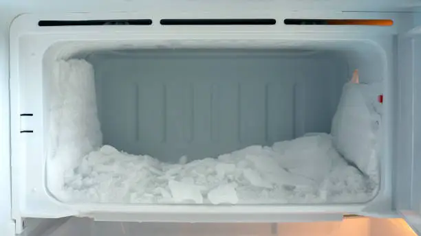 Ice buildup in an empty refrigerator.