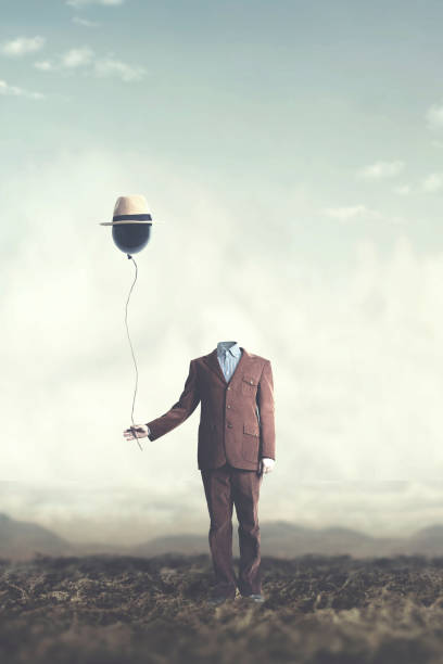 istock man without head holds black balloon with hat surreal concept 978274150