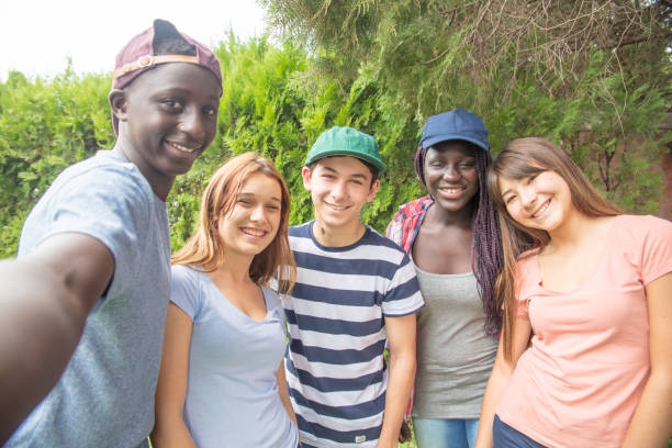 istock Multi ethnic teenagers group making selfie having fun in a park 978277240