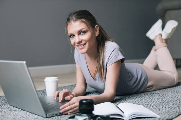 istock Positive girl with laptop surfing Internet. 978277418