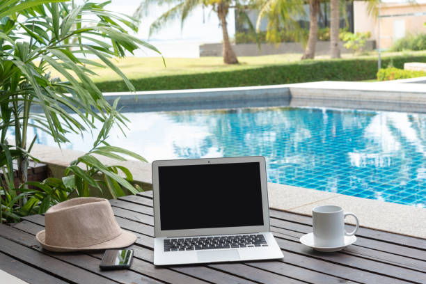 istock laptop and hat at the pool. 978277722