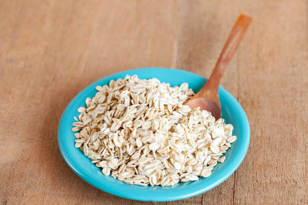 istock Oats flakes in dish on wood table 978285474
