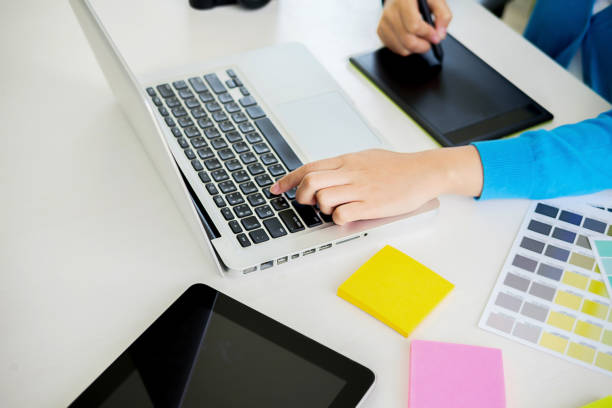 Graphic design and color swatches and pens on a desk. Architectural drawing with work tools and accessories.