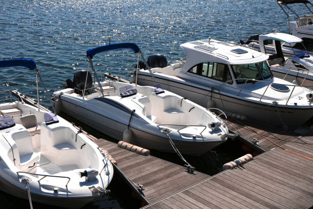 a pleasure boat lining the pier of the marina - marina imagens e fotografias de stock