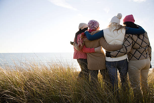 Female friends by the sea  marram grass photos stock pictures, royalty-free photos & images