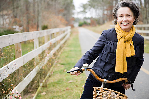 Mature woman on a bicycle  scarf photos stock pictures, royalty-free photos & images