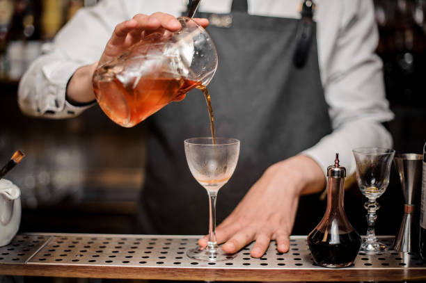 istock Barman pouring fresh alcoholic drink into the cocktail glass 978310676