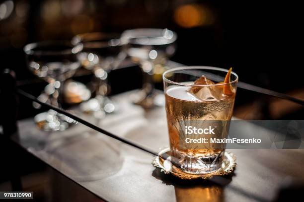 Fresh Old Fashioned Summer Cocktail With Ice And Orange Peel Stock Photo - Download Image Now
