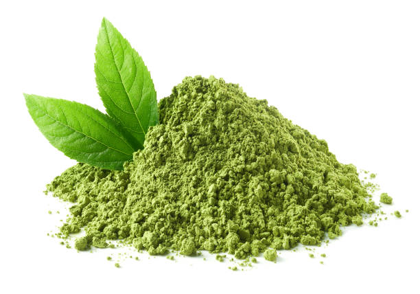 Heap of green matcha tea powder and leaves Heap of green matcha tea powder and leaves isolated on white background matcha tea photos stock pictures, royalty-free photos & images