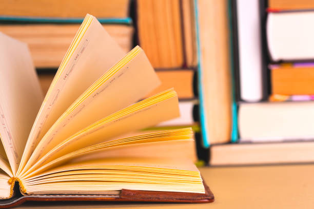 istock Open book, hardback books on bright colorful background. 978320968