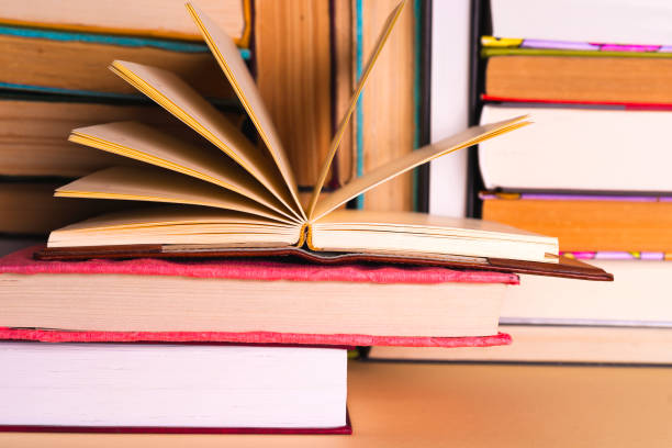 istock Open book, hardback books on bright colorful background. 978321090