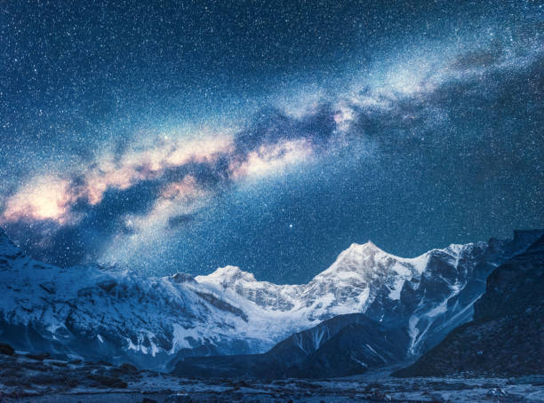 Milky Way and Beautiful Manaslu, Himalayas. Amazing view with himalayan mountains and starry sky at night in Nepal. High rocks with snowy peak and sky with stars. Night landscape with bright milky way Milky Way and Beautiful Manaslu, Himalayas. Amazing view with himalayan mountains and starry sky at night in Nepal. High rocks with snowy peak and sky with stars. Night landscape with bright milky way brightly lit winter season rock stock pictures, royalty-free photos & images