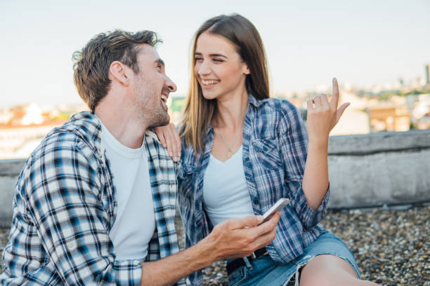 istock Couple on the roof smiling at each other 978332160