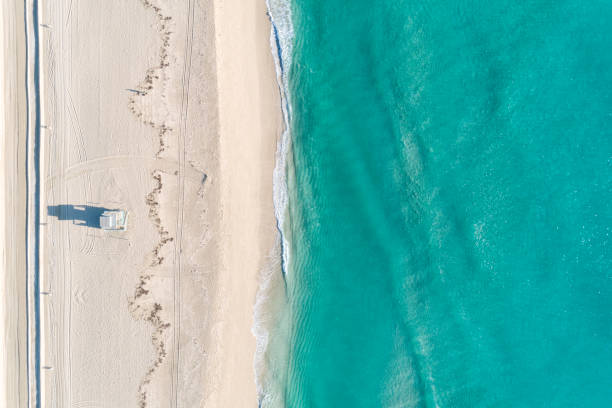 Aerial View Of Beach With Blue Waters Aerial view of the beach with blue waters in some tropical location. Directly above. miami beach stock pictures, royalty-free photos & images