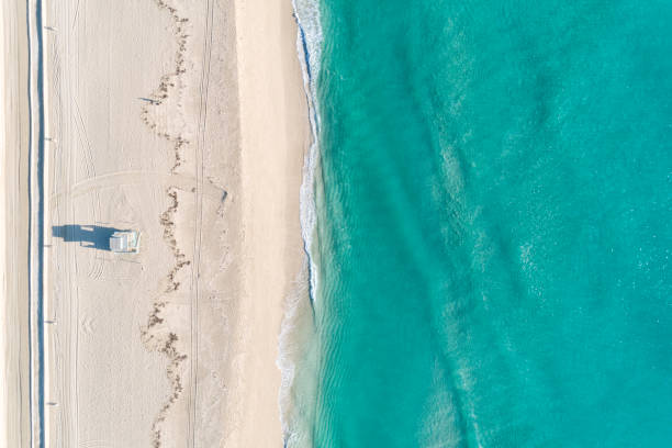 Aerial View Of Beach With Blue Waters Aerial view of the beach with blue waters in some tropical location. Directly above. florida beach above stock pictures, royalty-free photos & images